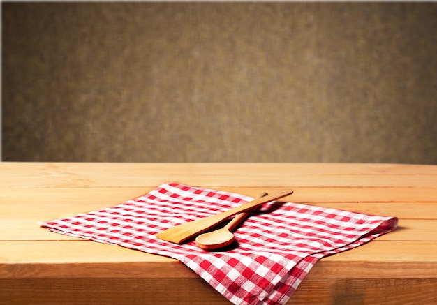 Wooden spoon and fork on checkered napking