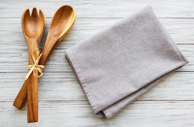 A wooden spoon, fork and napkin