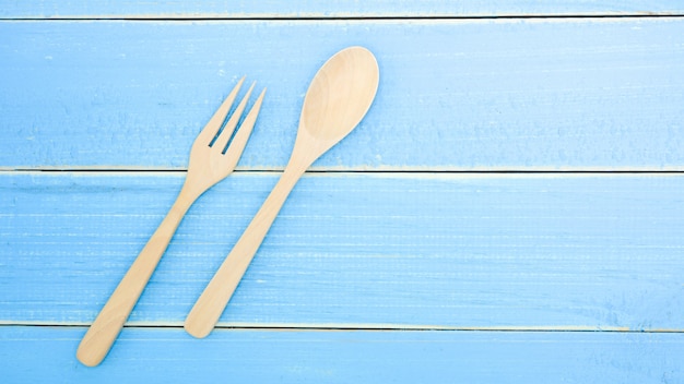 Wooden spoon and fork on old blue wood desk background