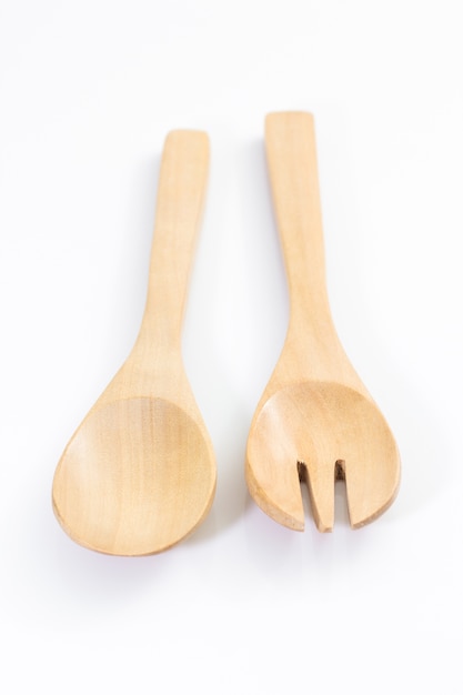 Wooden spoon and fork on white background