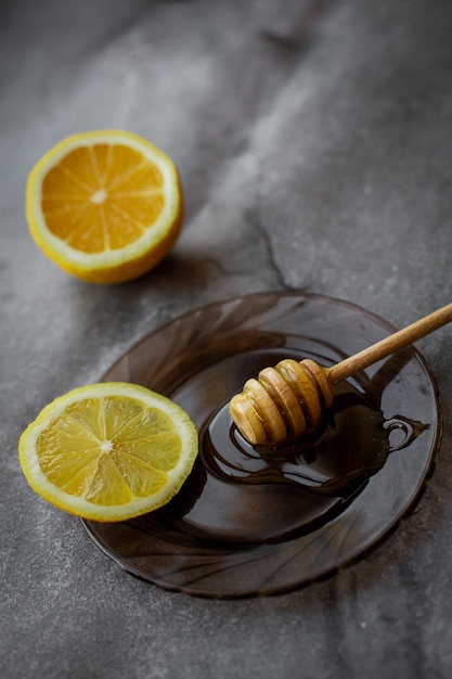 wooden spoon of honey with lemon