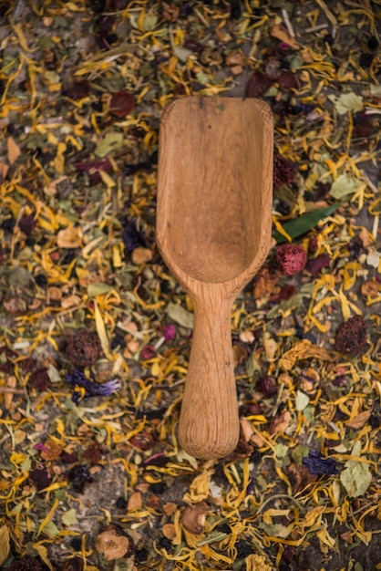 Wooden spoon on loose herbal tea