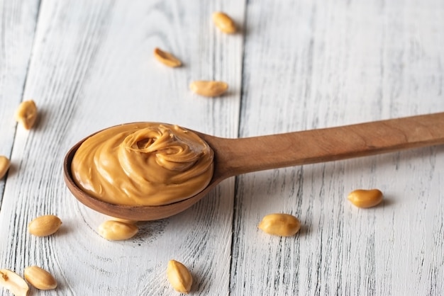 Photo wooden spoon of peanut butter