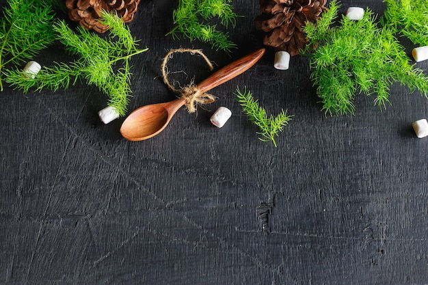 Wooden spoon and pine branches