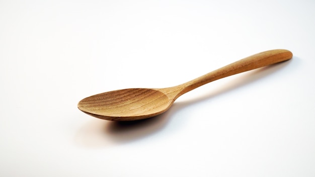 Wooden spoon on white background