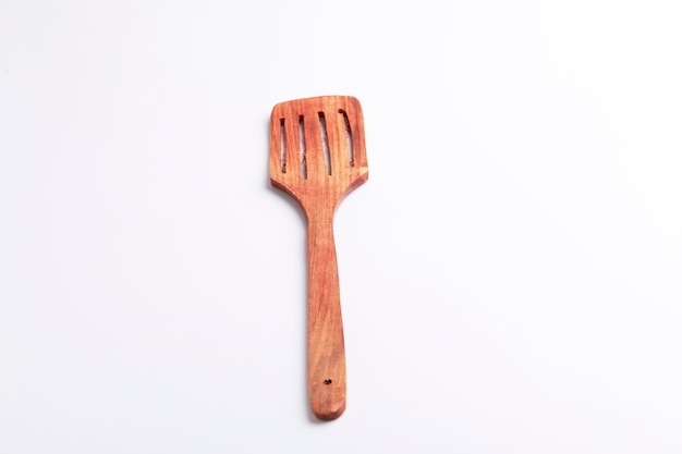 Wooden spoon on white background