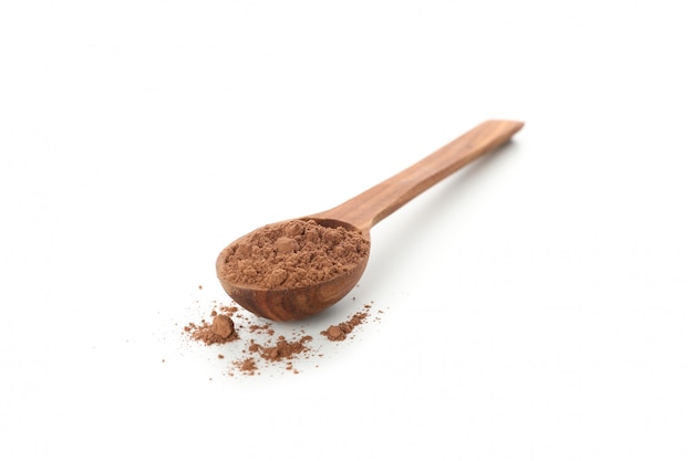 Wooden spoon with cocoa powder isolated on white