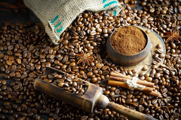 A wooden spoon with coffee beans and anise star on it