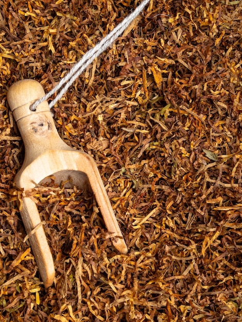 Wooden spoon with dry tobacco close up