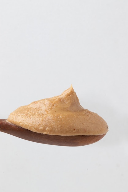 Wooden spoon with portion of peanut butter