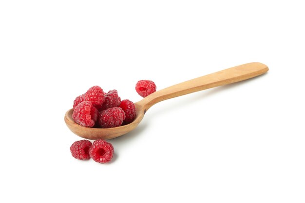 Wooden spoon with raspberries, isolated on white background.