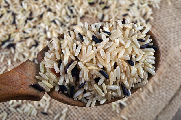 a wooden spoon with rice on it