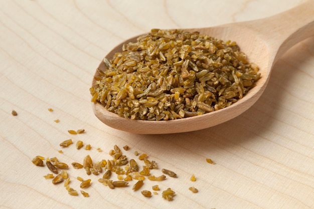 Wooden spoon with roasted Freekeh close up