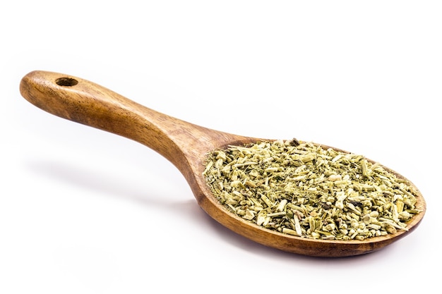 Wooden spoon with yerba mate on isolated white surface