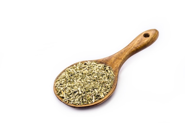 Photo wooden spoon with yerba mate on isolated white surface