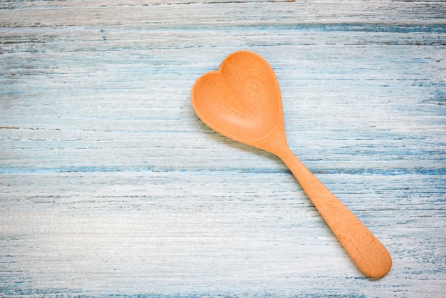 Wooden spoon on wooden table wall , top view - Coffee spoon heart shape , Love health or love cooking concept