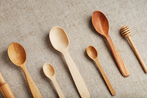 Wooden spoons made of natural wood on burlap fabric as a craft.
natural natural materials. caring for the environment