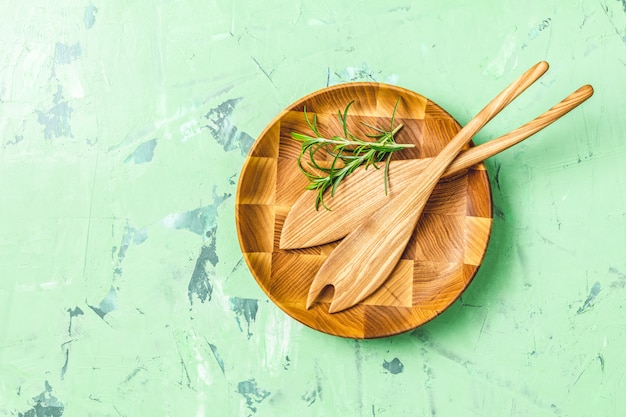 Wooden spoons for salad in wooden plate