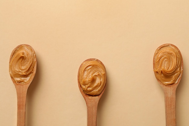 Wooden spoons with peanut butter isolated