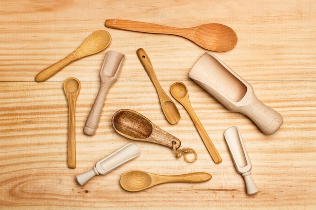 Wooden spoons on a wooden table in a top view