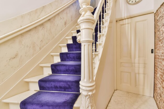 Wooden staircase in spacious hall of apartment