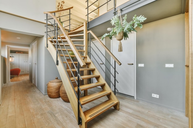 Wooden staircase in spacious hall of apartment