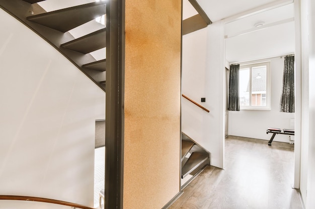 Wooden staircase in spacious hall of apartment