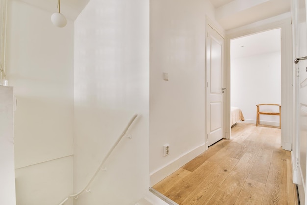 Wooden staircase in spacious hall of apartment