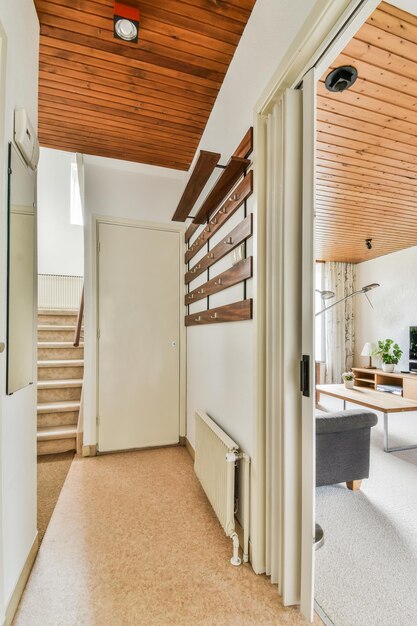 Wooden staircase in spacious hall of apartment