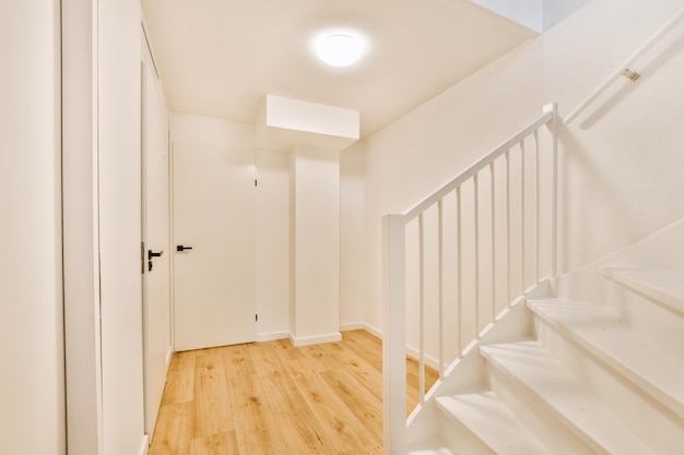 Wooden staircase in spacious hall of apartment