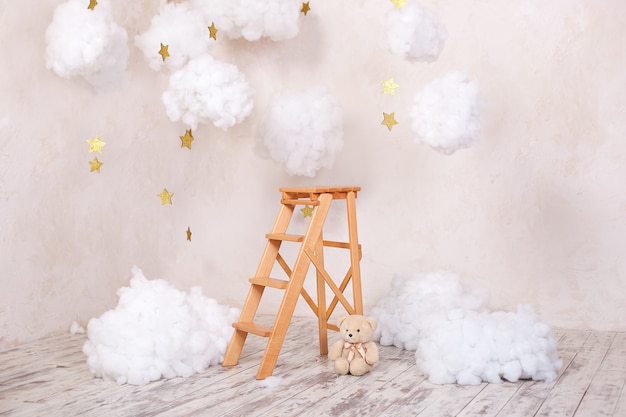Wooden staircase stool with clouds in the children room. Scandinavian style. Rustic room interior. Christmas holiday decorations.