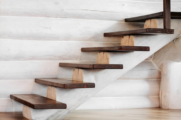 A wooden staircase with a wooden log in the house