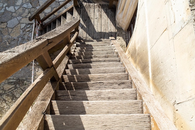 a wooden staircase with a wooden plank that has the word  on it