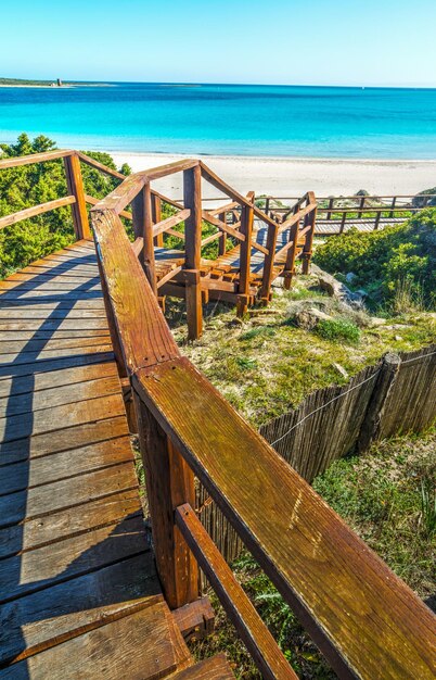 Wooden stairs to the beach in Sardinia Italy