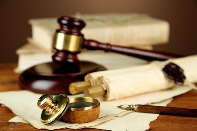 Wooden stamp gavel and old papers on wooden table