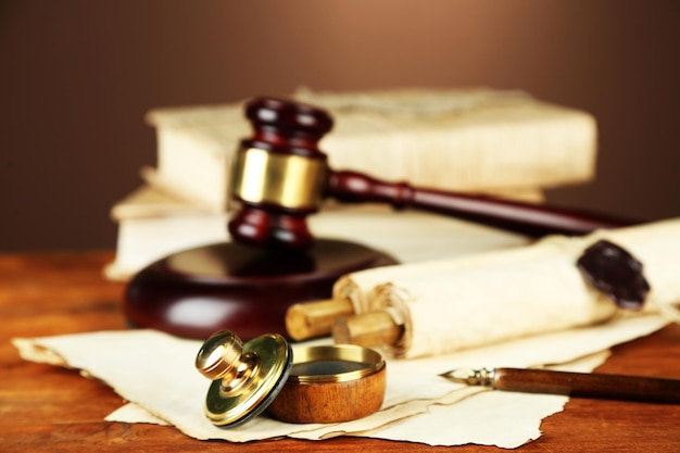 Wooden stamp gavel and old papers on wooden table