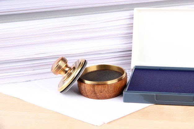 Photo wooden stamp and papers on table