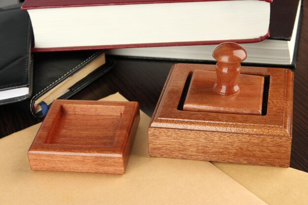 Photo wooden stamp with notepads and books on table