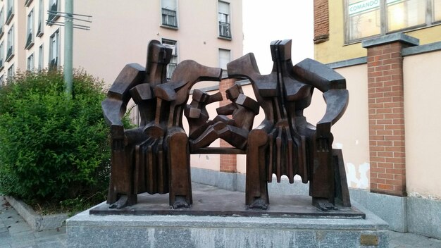 Wooden statues by building