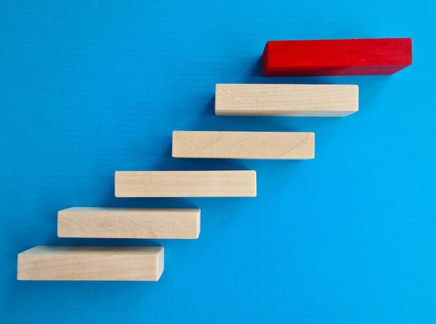 Wooden steps and red block on top closeup