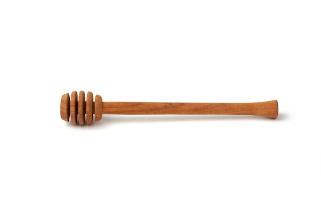 Wooden stick for stirring honey isolated