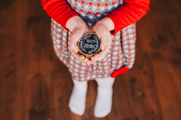 Wooden stump in children's hands with the words