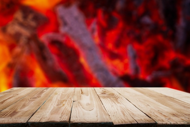 Wooden surface against background of flames