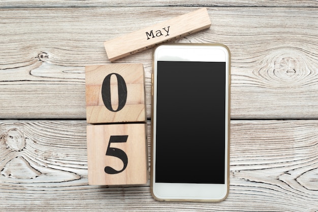 wooden surface cube shape calendar fo 5 May on wooden surface 