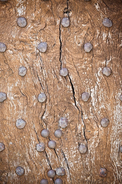 Wooden surface with old metal rivets background