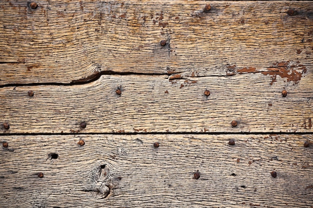 Wooden surface with old metal rivets background