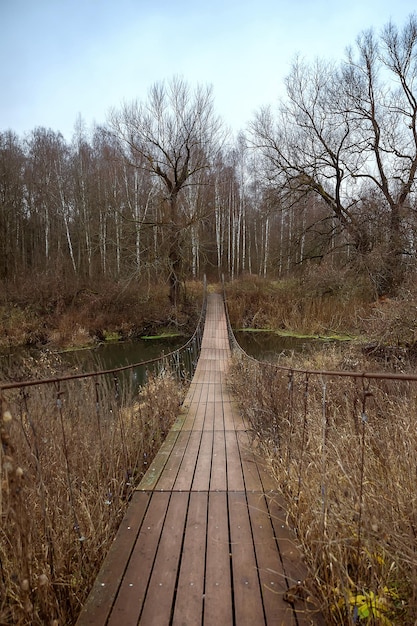 Wooden suspension bridge over the river