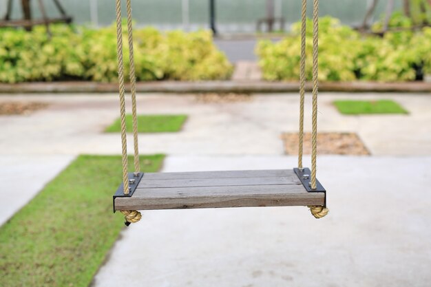 Wooden swing in the garden.