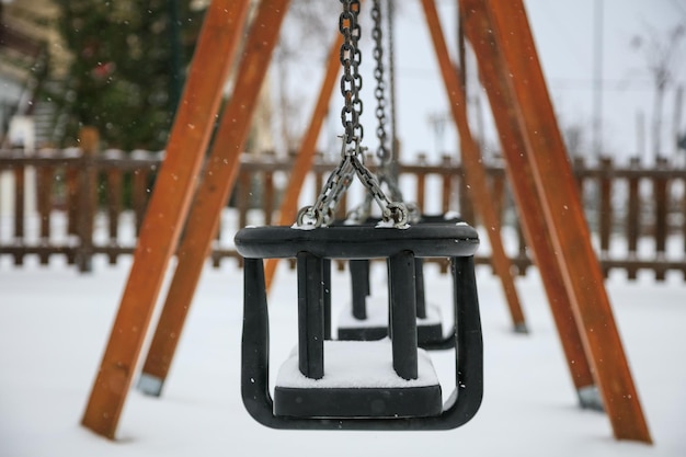 Wooden swing on snow