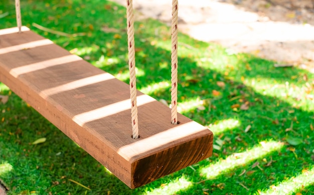 Wooden swings are placed in a lush green garden In a small restaurant In the midst of the autumn atmosphere